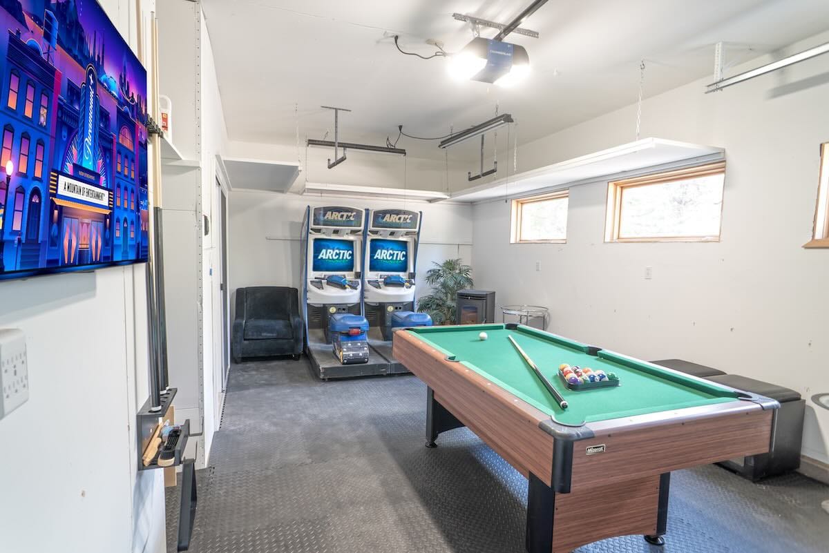 Game room with pool table and arcade machines