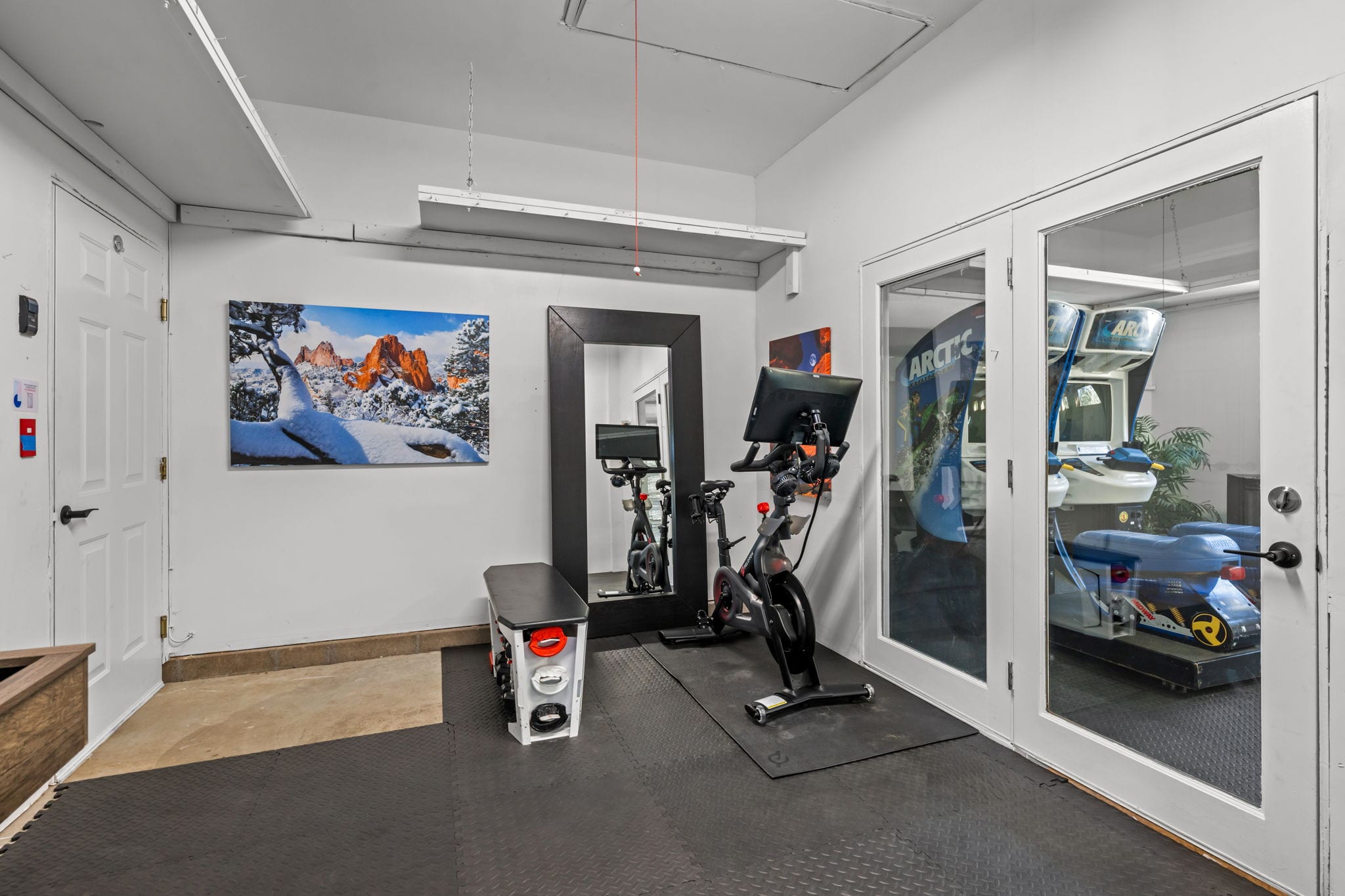Fitness corner with stationary bike and a bench with weights