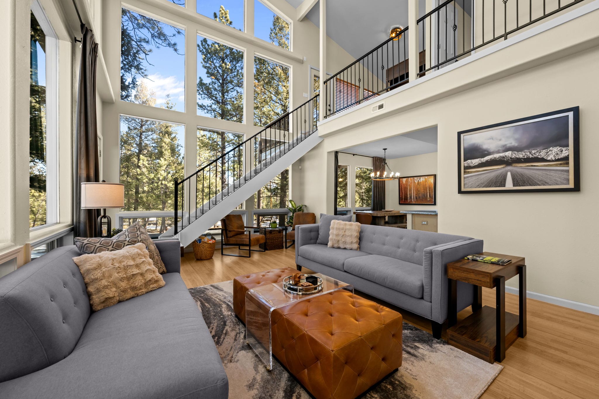 Wide angle of the living room, staircase and walls of windows